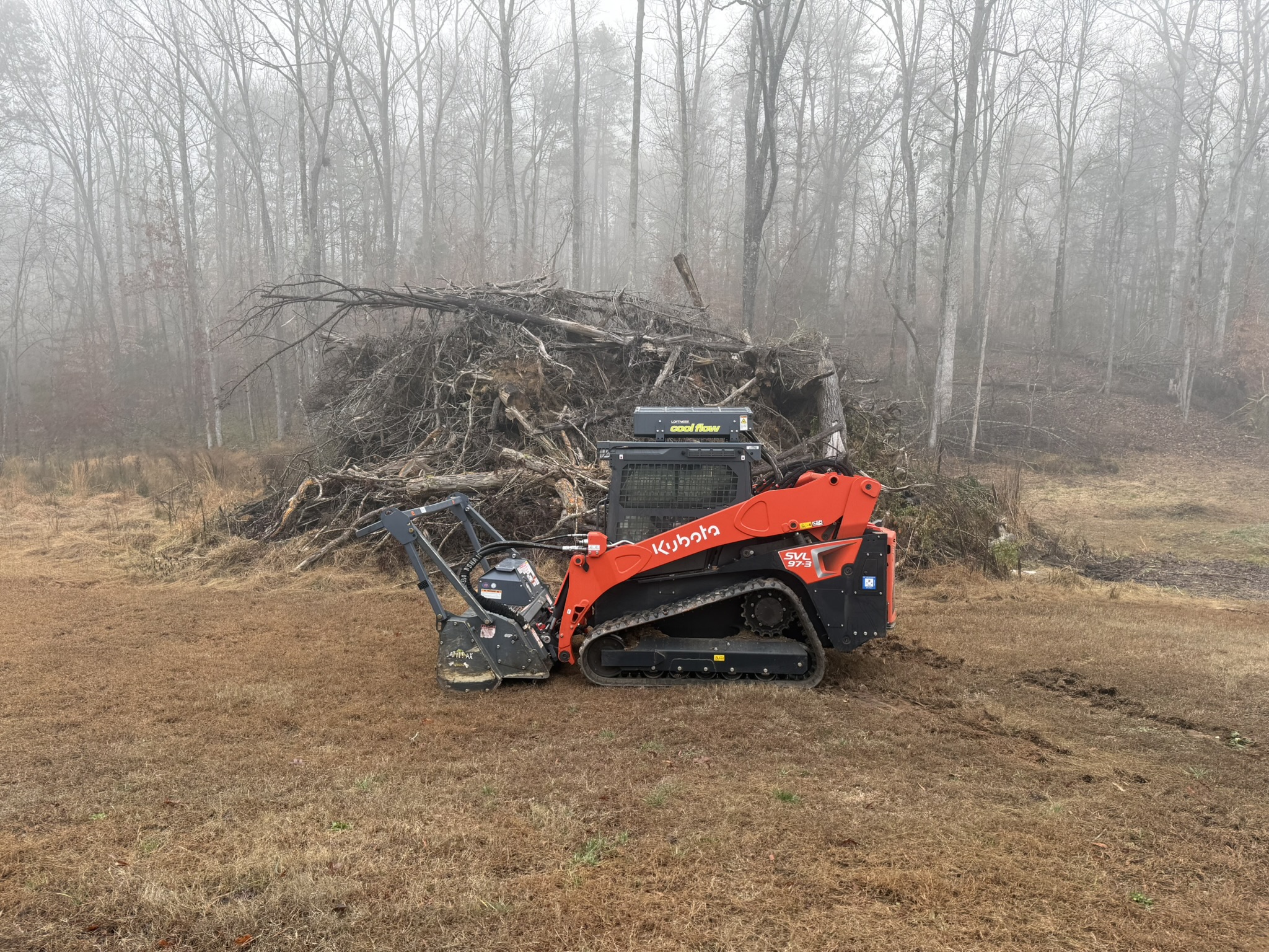“Large brush pile covering residential property before professional brush pile removal in Greenwood SC”