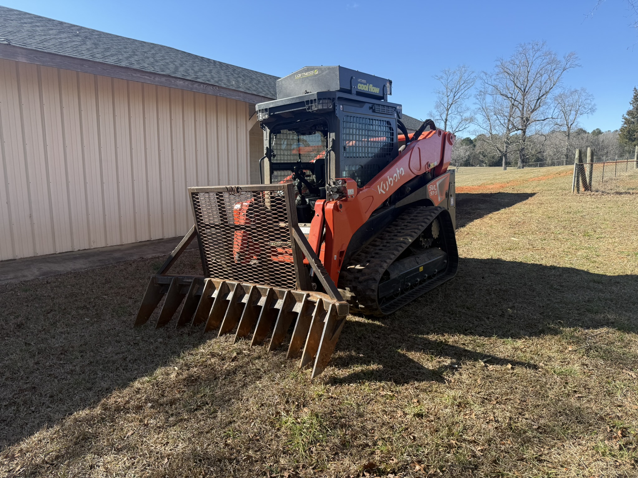 skid steer with root rake attachment